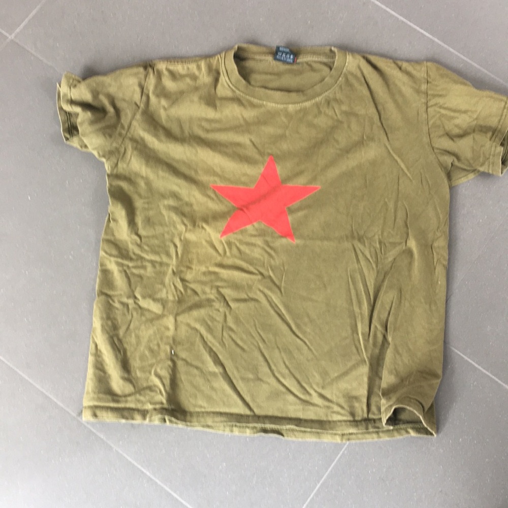 green t-shirt with a red star on it
